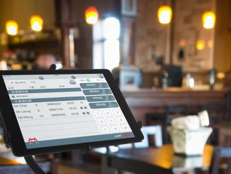 POS terminal in coffee cafe with software interface to take order and print receipt.